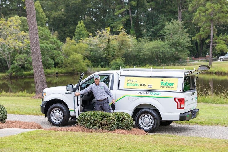 A Tabor pest control employee is about to provide pest control services to a homeowner