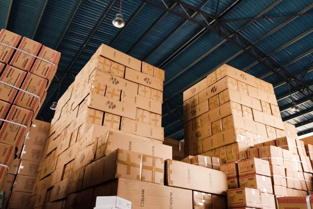 A huge inventory of cardboard boxes stacked in a commercial warehouse